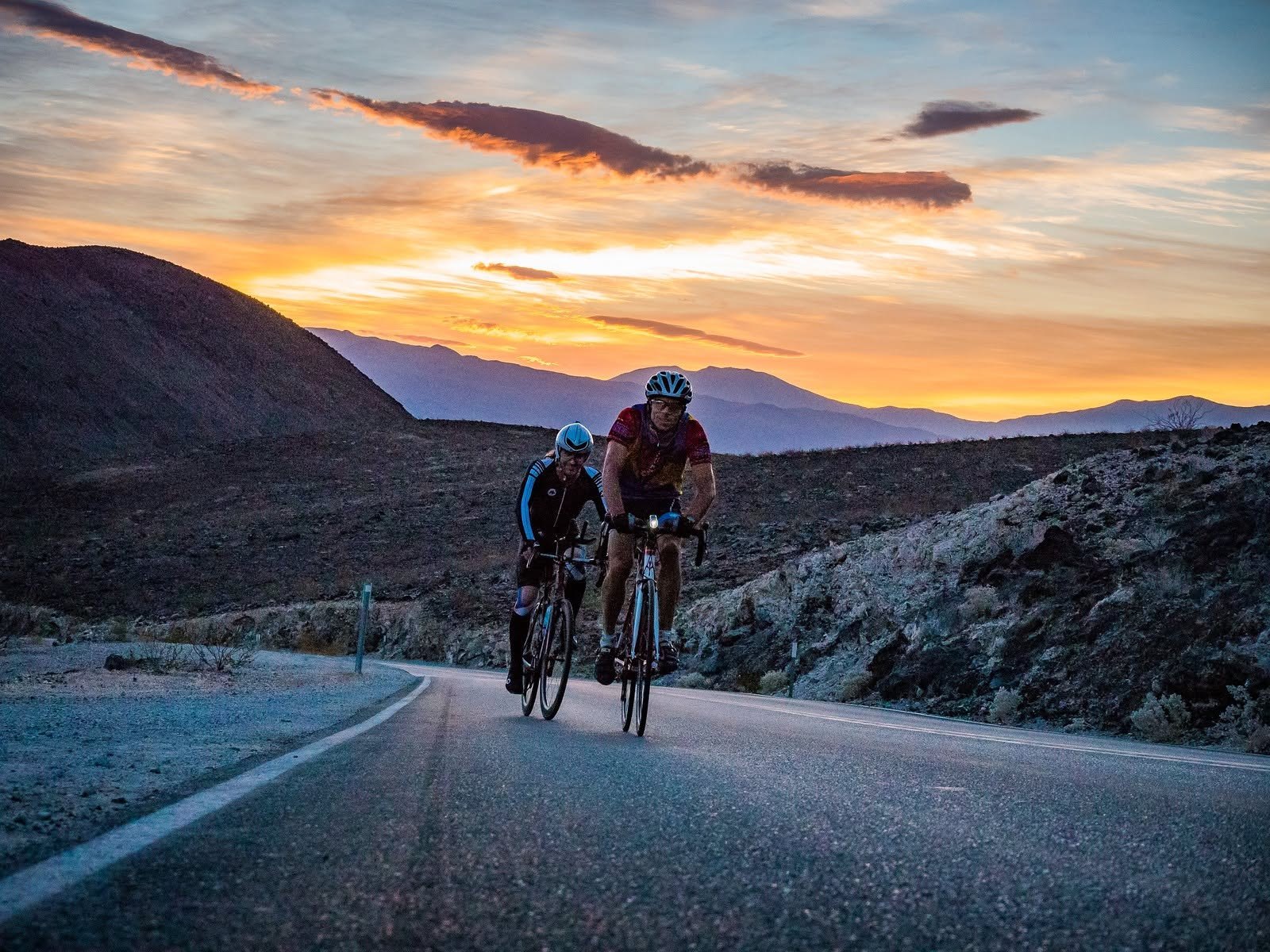 Ryan Tetz and Brent Obinger ride through the desert at sunrise during an early trial