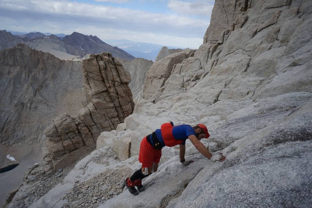 A climber moves across pale high-elevation Whitney granite
