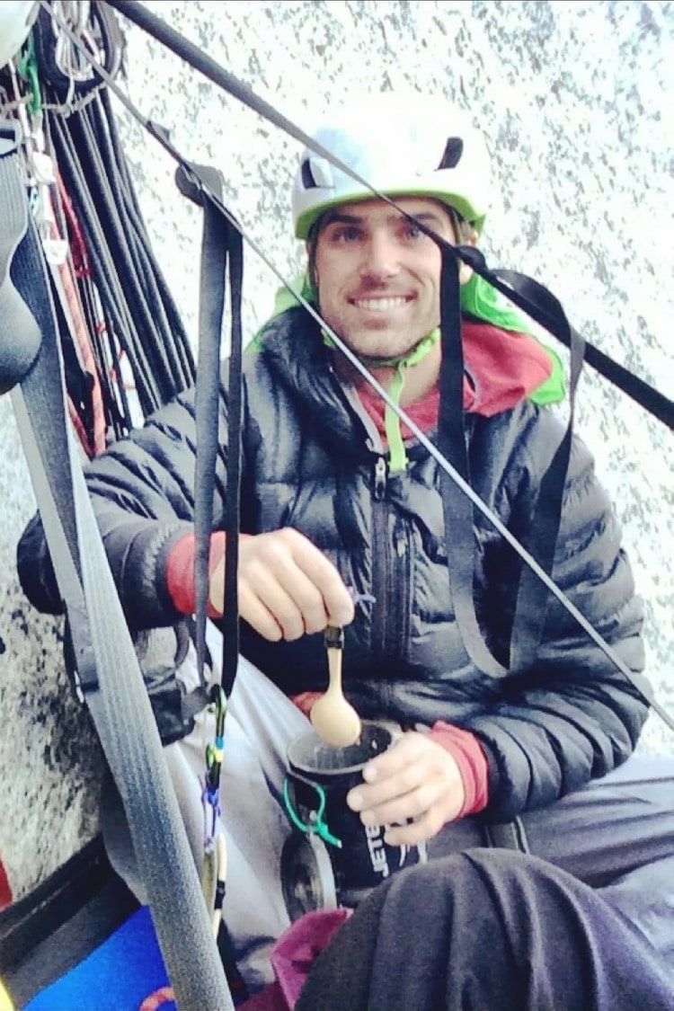 Josh Dibble smiles from a hanging bivouac on El Capitan