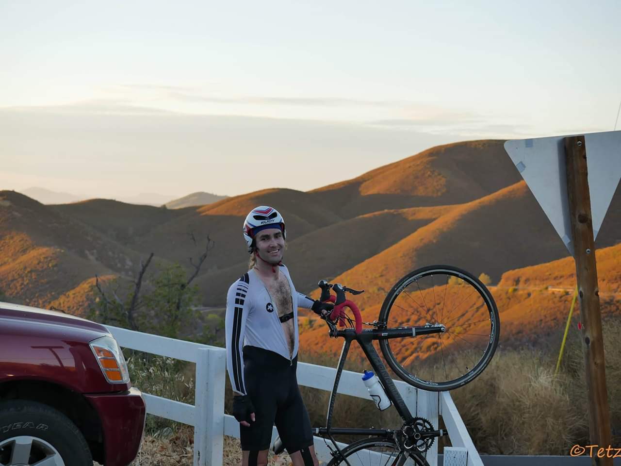 Ryan Tetz lifts the front wheel of his road bicycle at the top of Priest Grade during the 2014 Link-Up
