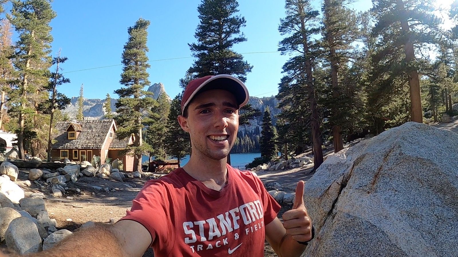 Meikael Beaudoin-Rousseau smiles at Lake George with Crystal Crag rising behind him