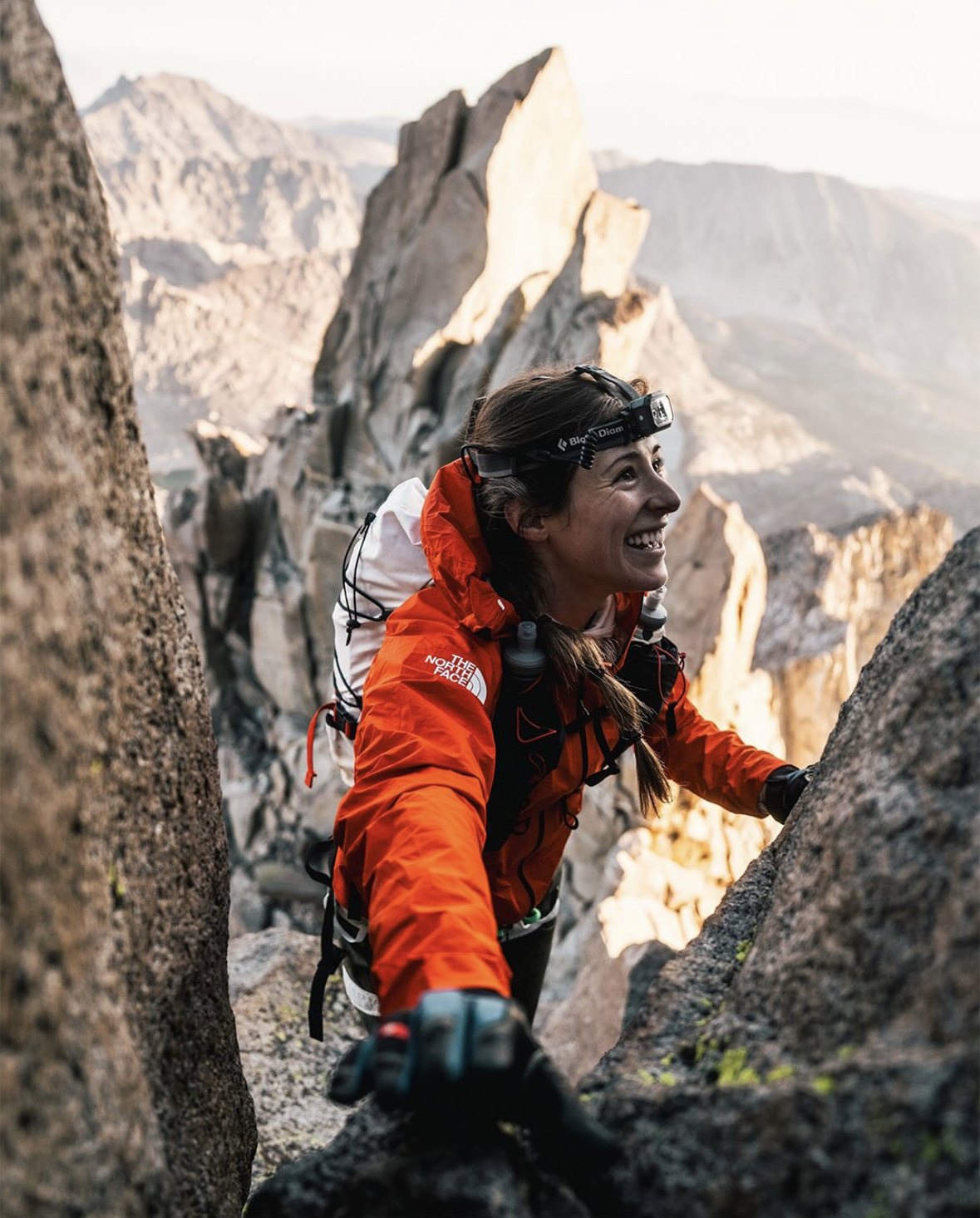 Olivia Amber smiles while climbing through high Sierra granite