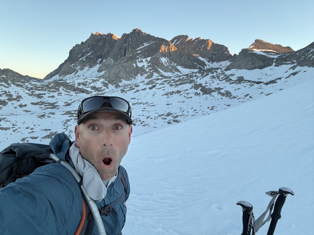 Ryan Soares takes a ski-mountaineering selfie below the snowy Monarch Divide at sunrise