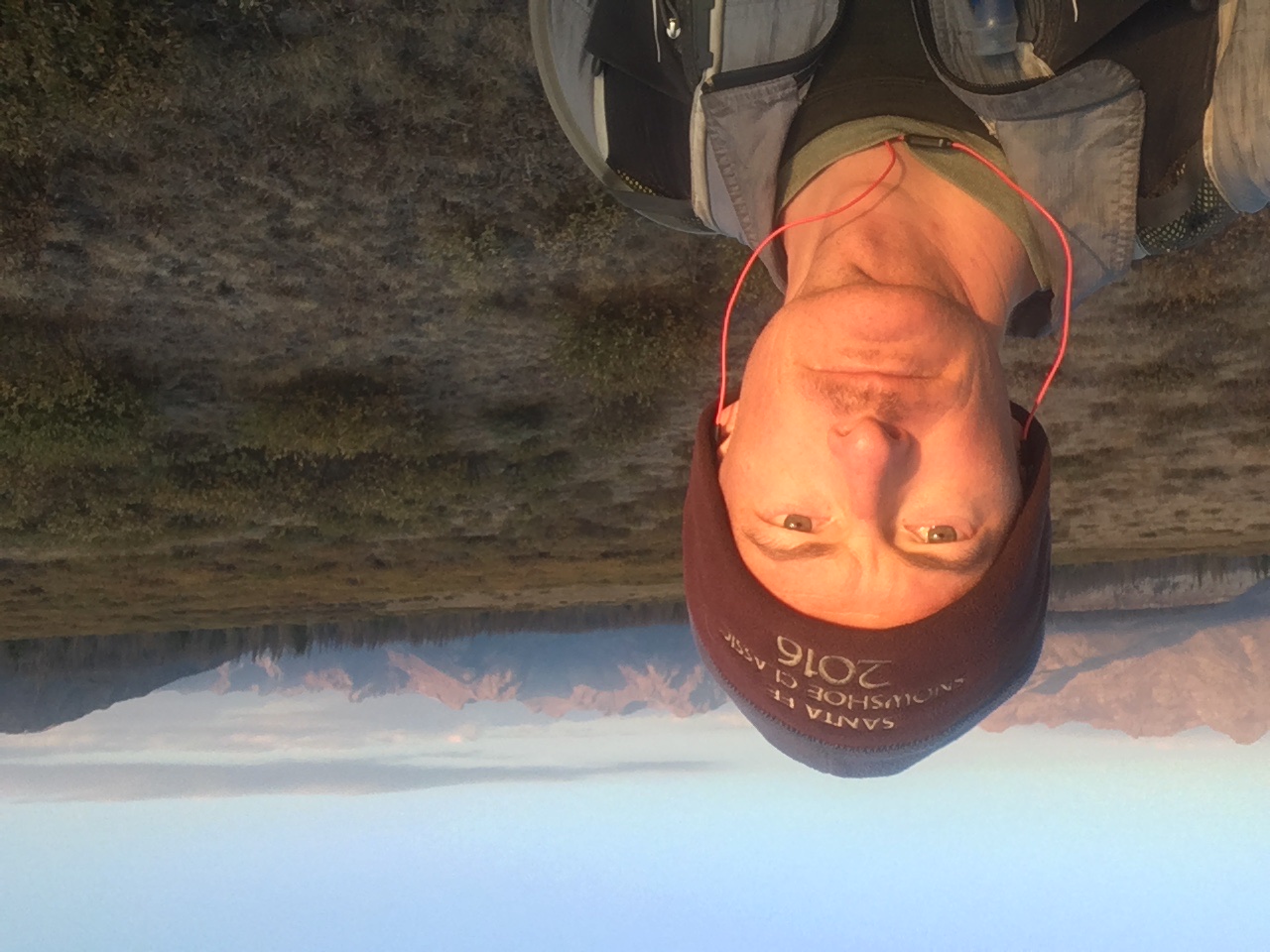 Sean O’Rourke takes a mountain selfie at sunrise with a high range behind him