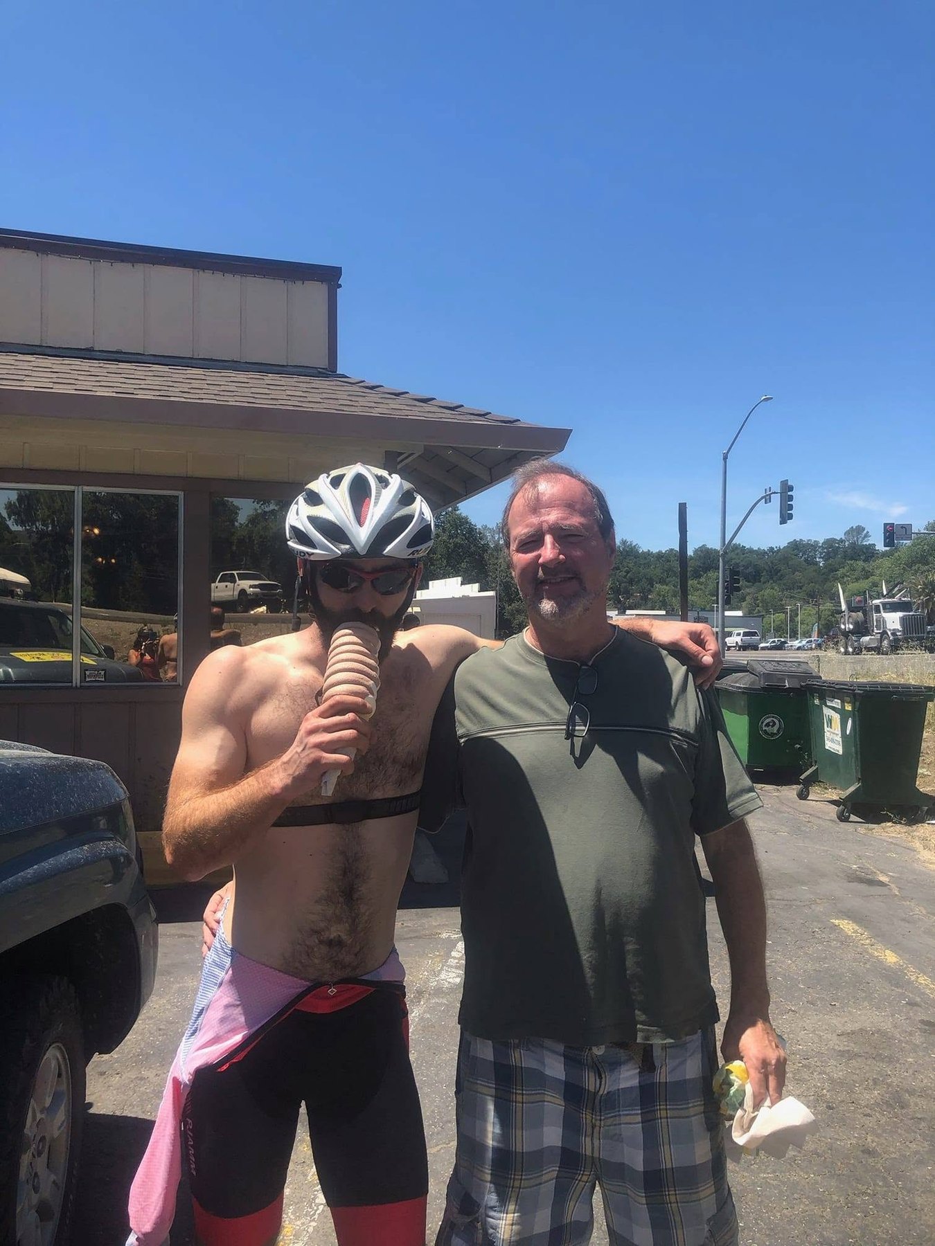 Ryan Tetz eats an ice cream beside his father at the midpoint of the 2019 Triple Sierra Crossing