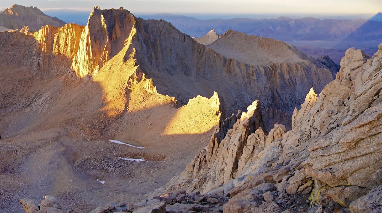 Golden evening light crosses the Mount Whitney–Mount Russell ridgeline and its broad fields of granite talus