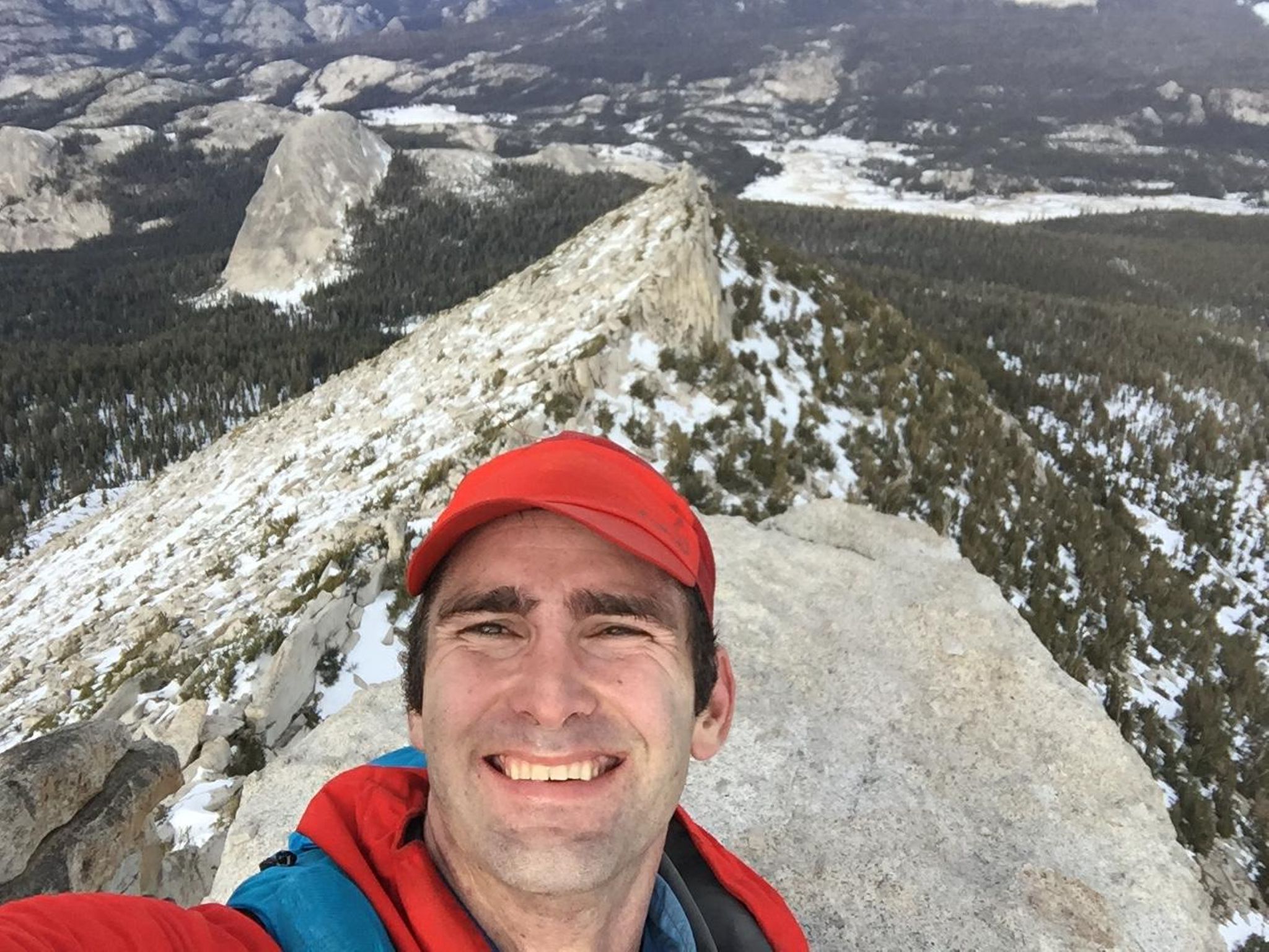 Ryan Tetz smiles on snowy Cathedral Peak during his 2018 solo Yosemite Winter Picnic